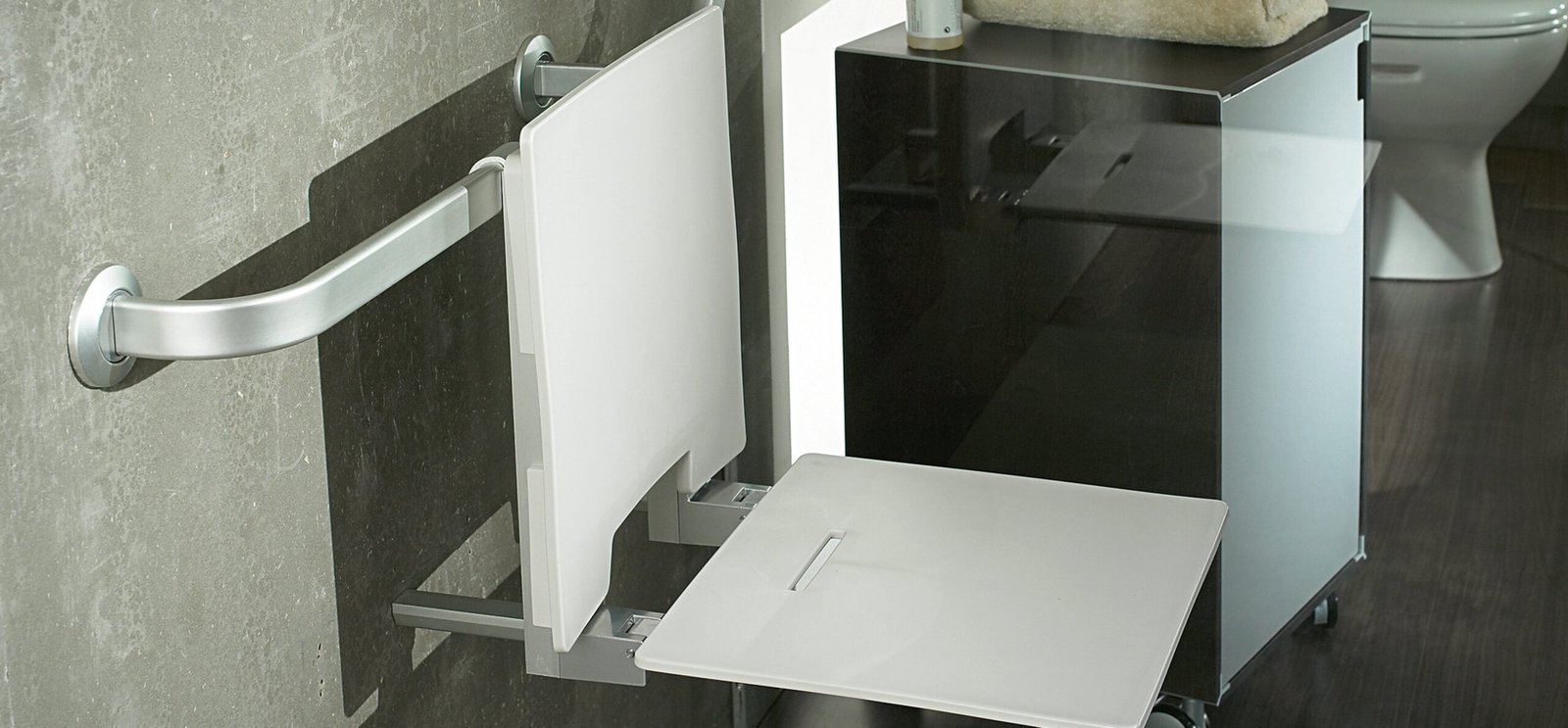 Accessible bathroom with grab bar and folding shower seat